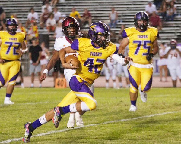 Lemoore quarterback Ty Chambers scrambles for a first down in Friday night's home game against Clovis West. 